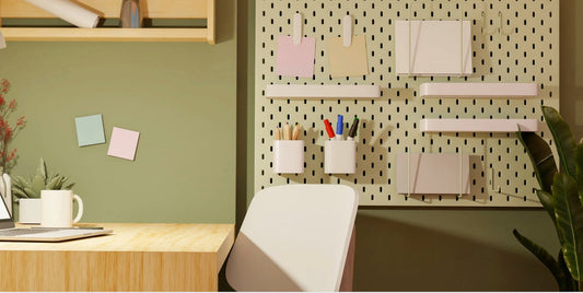 desk space with green wall and plant with shelves and sticky notes