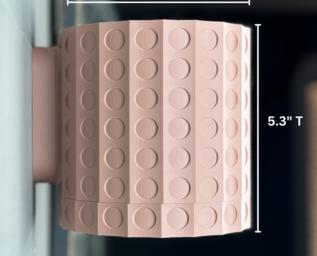 a pink wall mounted planter showing that it is 5.3" high on a light grey wall with dark background