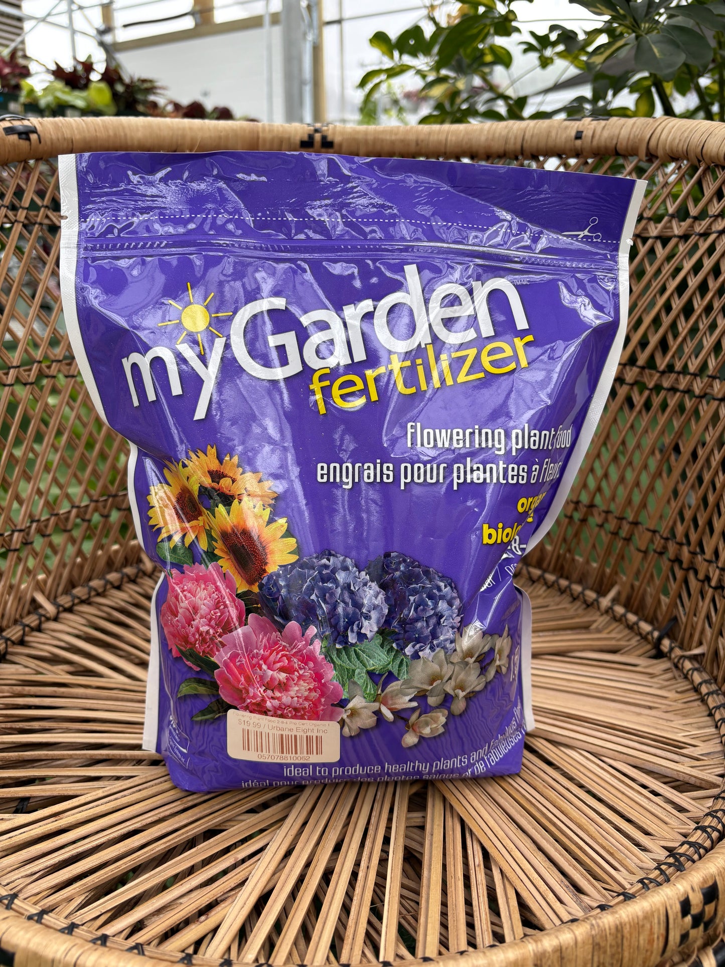 Bag of garden fertilizer labeled 'myGarden' on a wicker surface