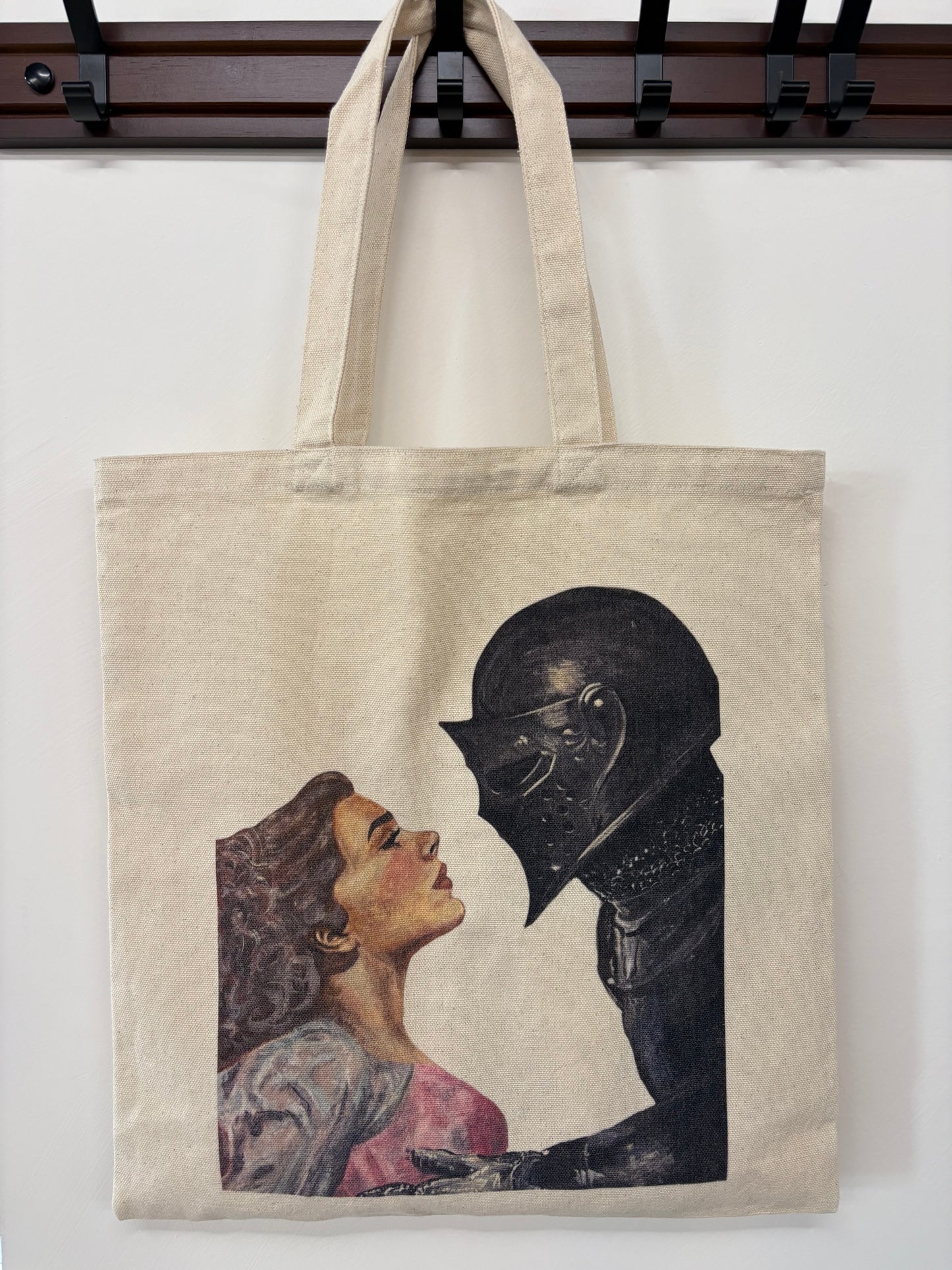 Tote bag with a design of a person in armor and a woman on a white background