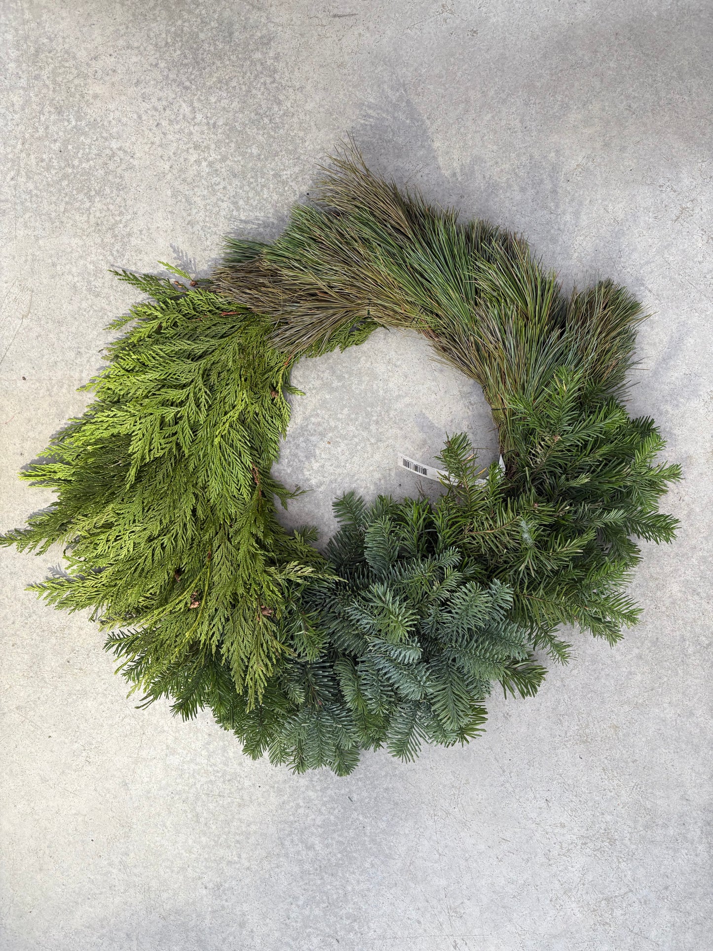 Green Modern Block Wreath 24" on a light gray surface