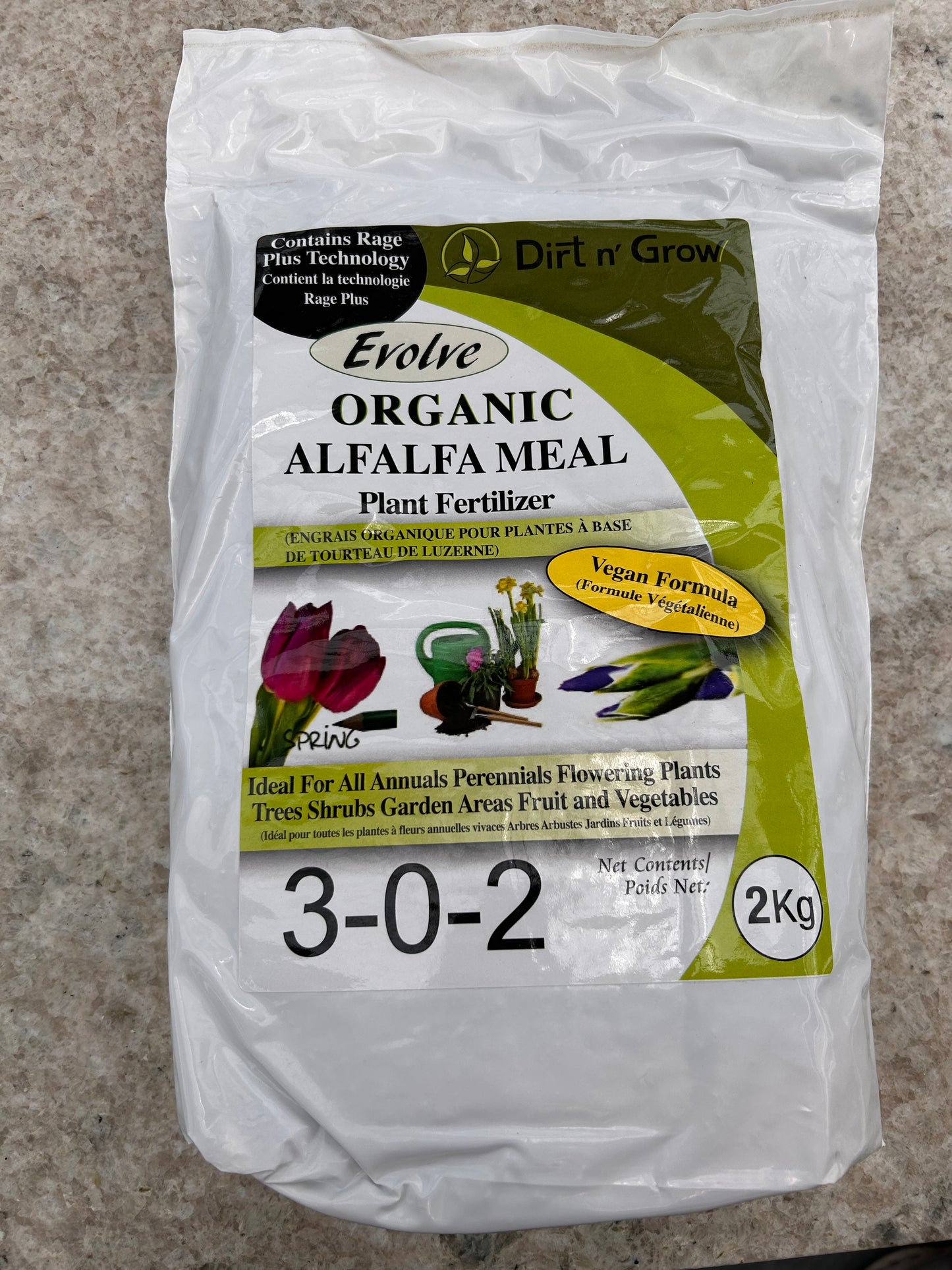 Package of Evolve Organic Alfalfa Meal plant fertilizer on a concrete surface