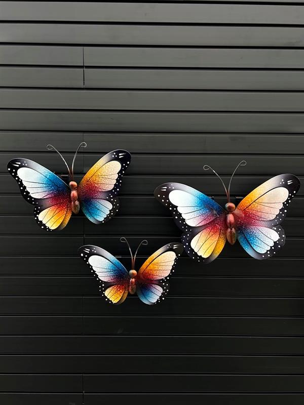 A set of three metal decorative butterfly plaques with black backgrounds, featuring multicolored butterfly designs.