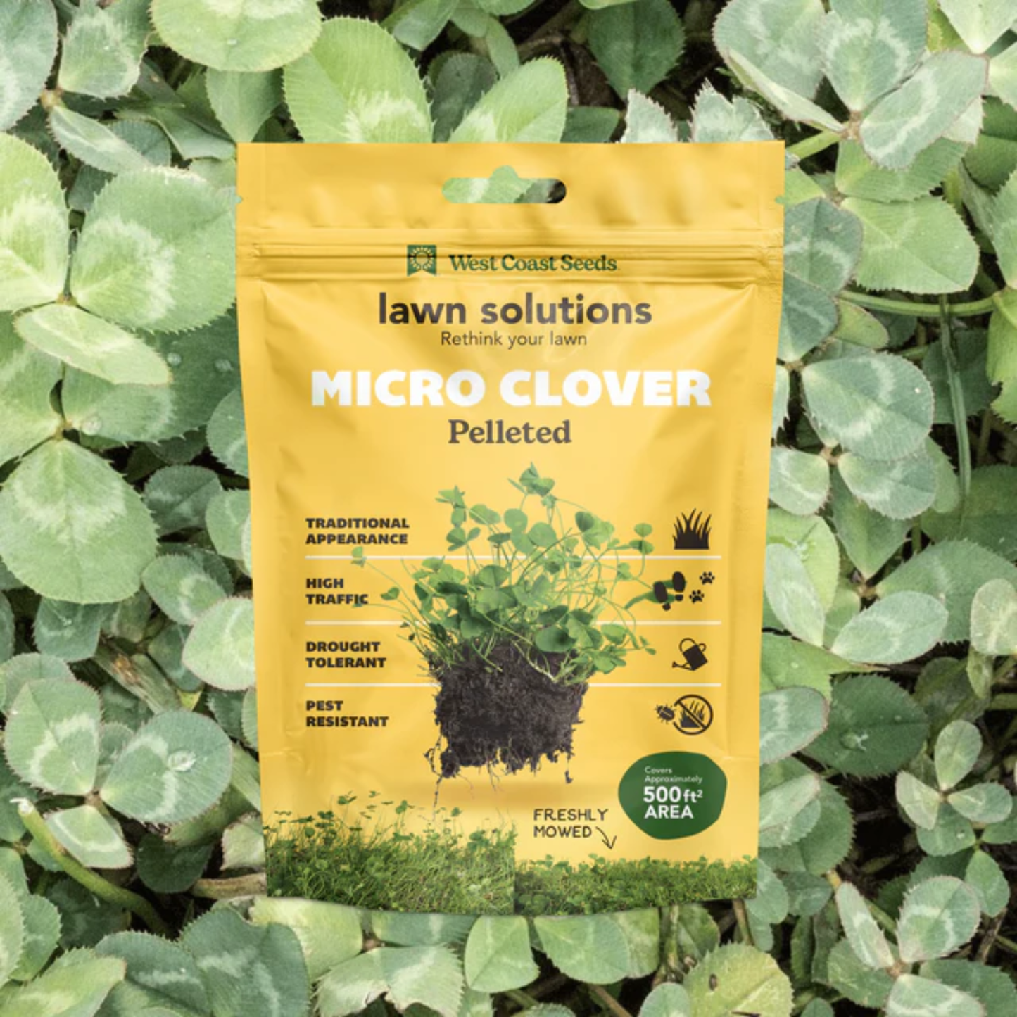 a yellow bag of lawn solutions micro clover against a background of clover