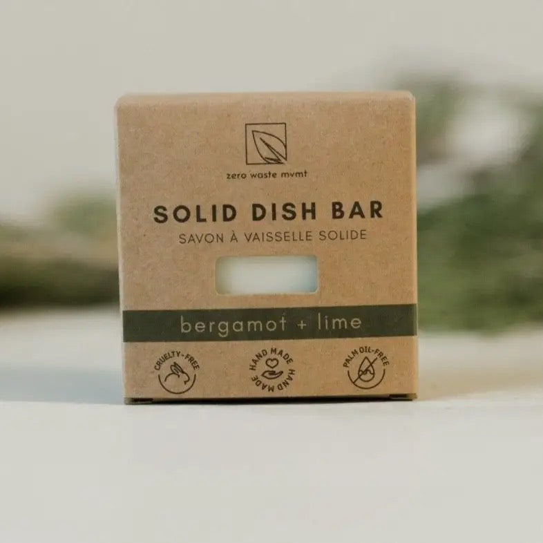 a natural solid dish bar in its cardboard packaging with the scents bergamot and lime written on the packaging