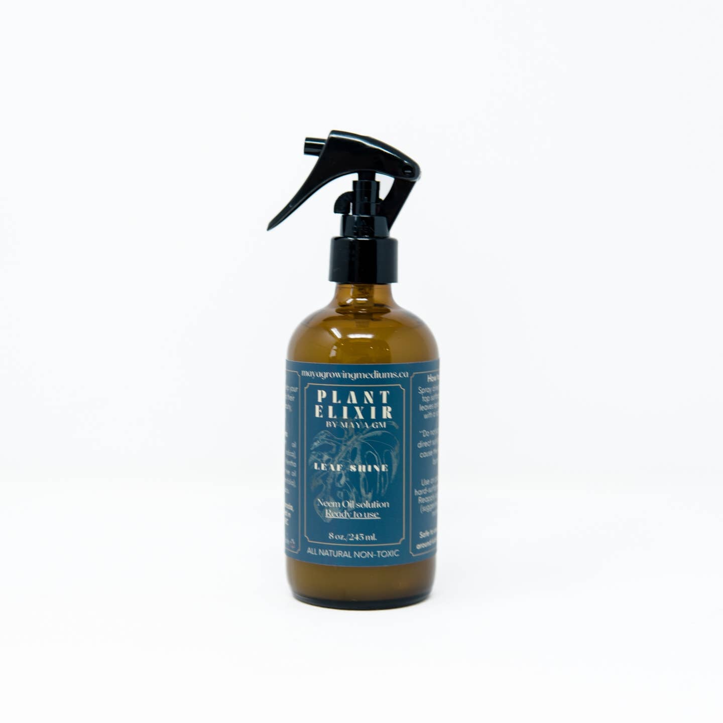 A 16 oz / 500 ml spray bottle of Plant Elixir Leaf Shine with a black spray nozzle. The label is blue with white and green text, and it is displayed against a white background.