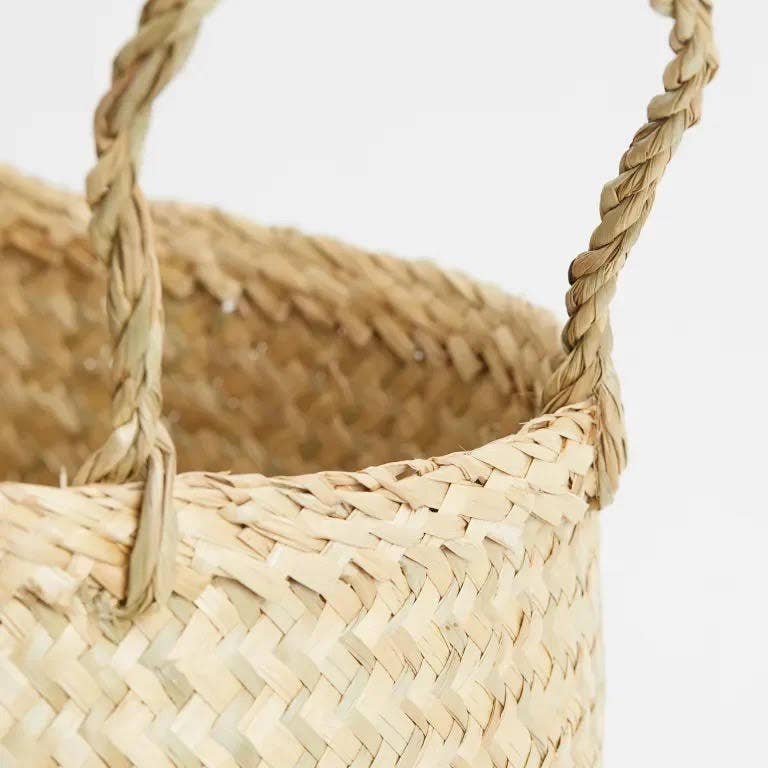 a close up of a woven seagrass planter basket