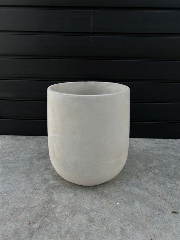 Round cement planter with a textured finish, placed against a black background.