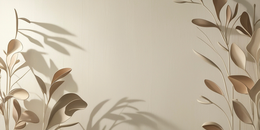 a beige wall with beige plants infront of the wall casting shadows