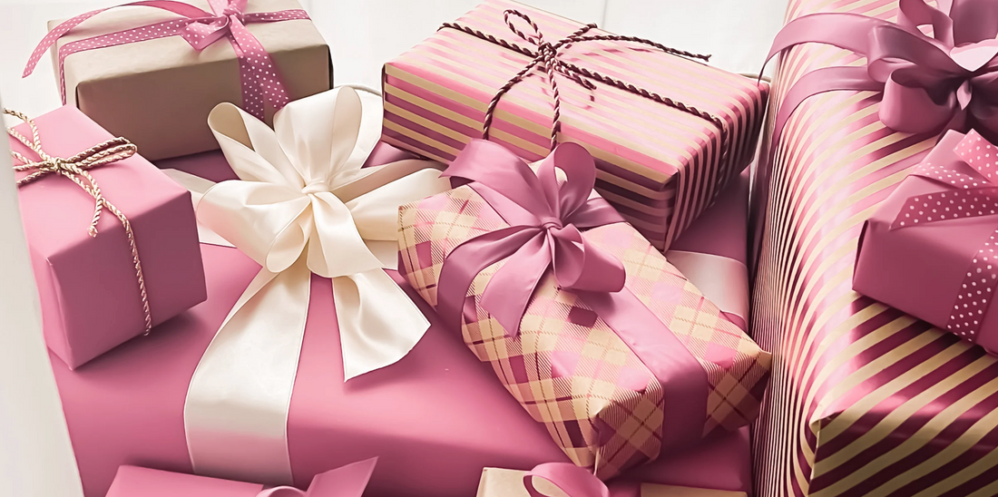 a pile of pink wrapped Christmas gifts