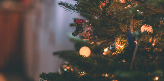 close up of a lit christmas tree with a blurred background