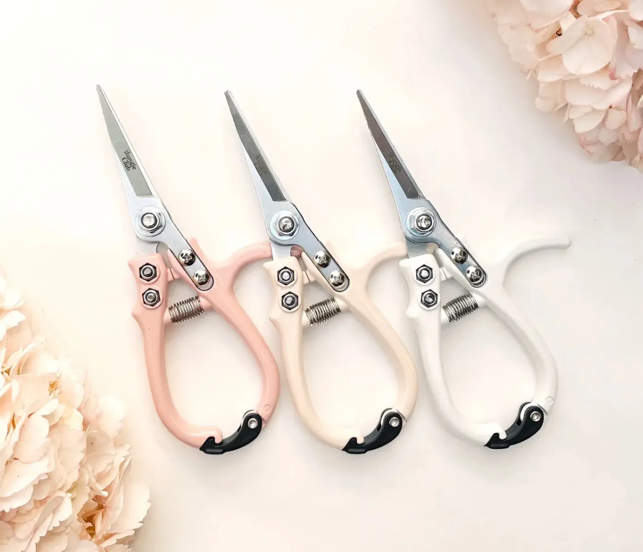 3 different pruning sheers against a plain background