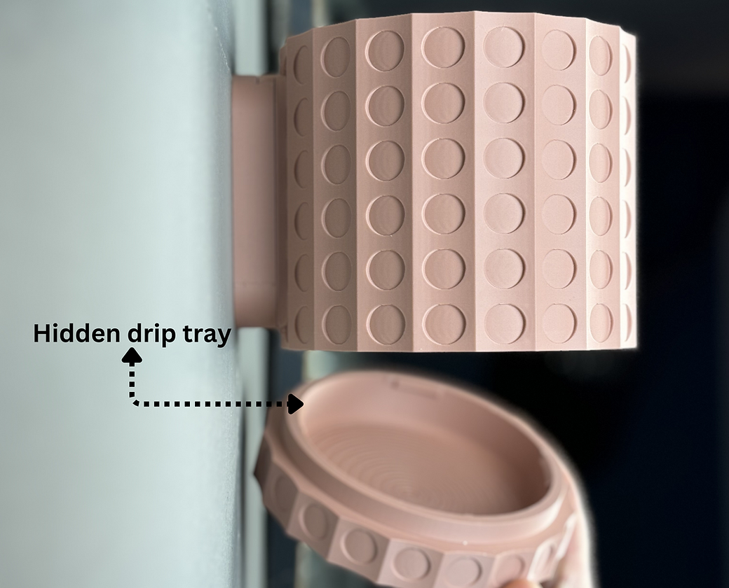 A picture of a pink wall mounted pot showing a removable drip tray on a white wall with dark background