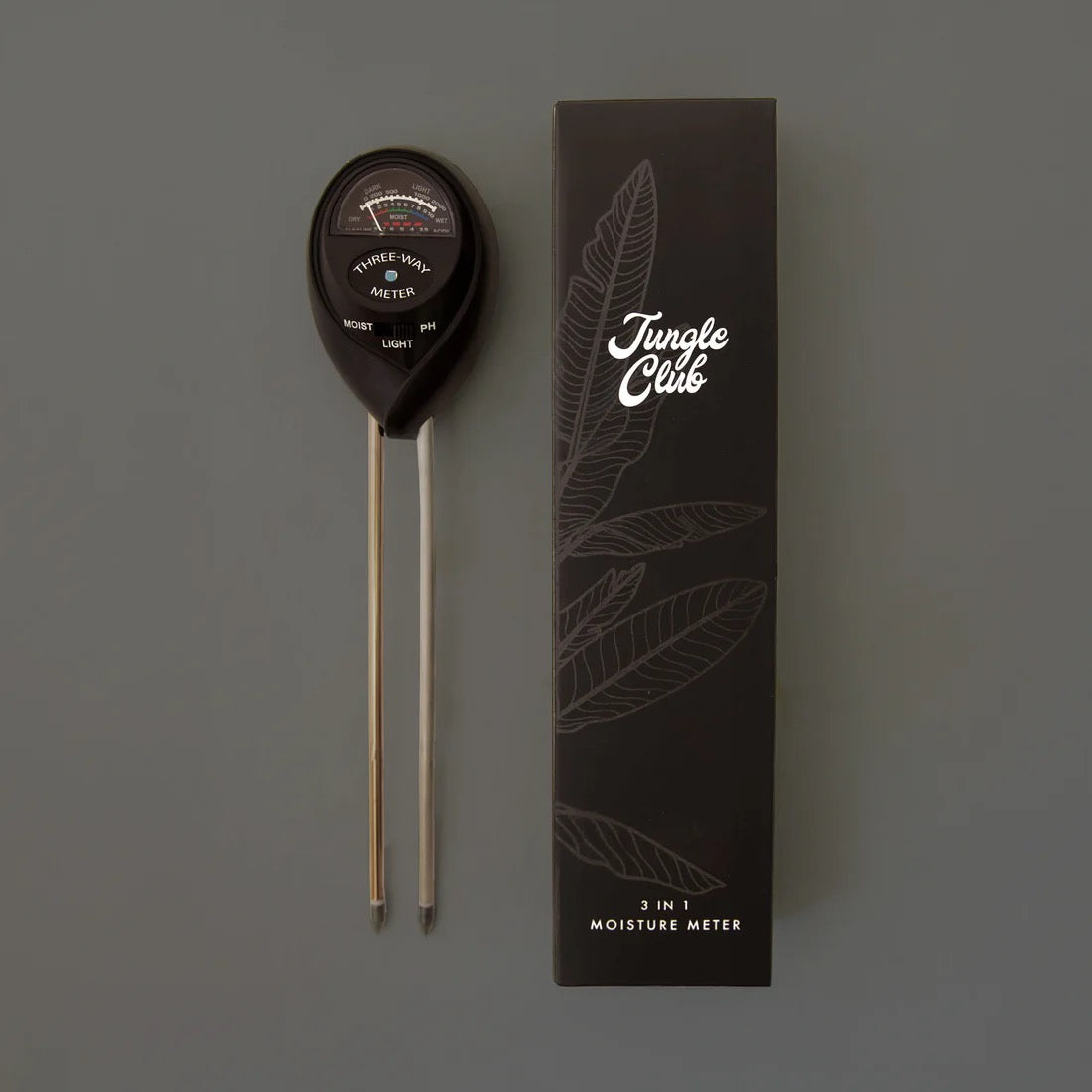 Moisture meter with 'Jungle Club' branded box on a gray background