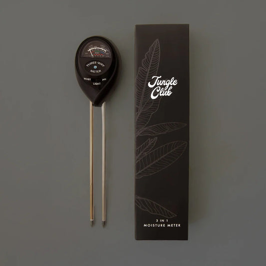 Moisture meter with 'Jungle Club' branded box on a gray background