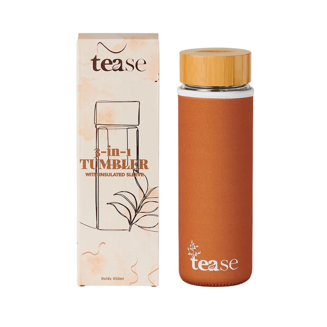 Orange tumbler with wooden lid and packaging labeled 'tease' on a white background