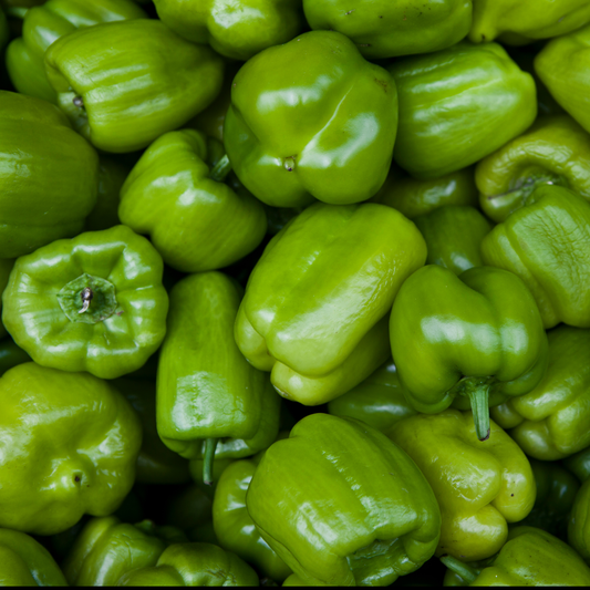 a large pike of bright green better belle v bell peppers with green stems