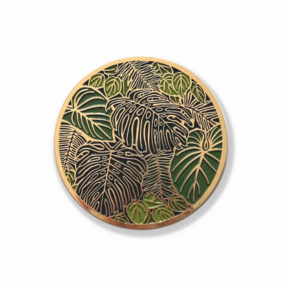 gold edged plant themed coaster on a white background