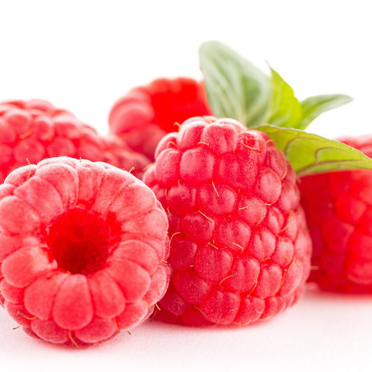 multiple bright red Boyne raspberries facing in multiple directions with green leaves and a white background