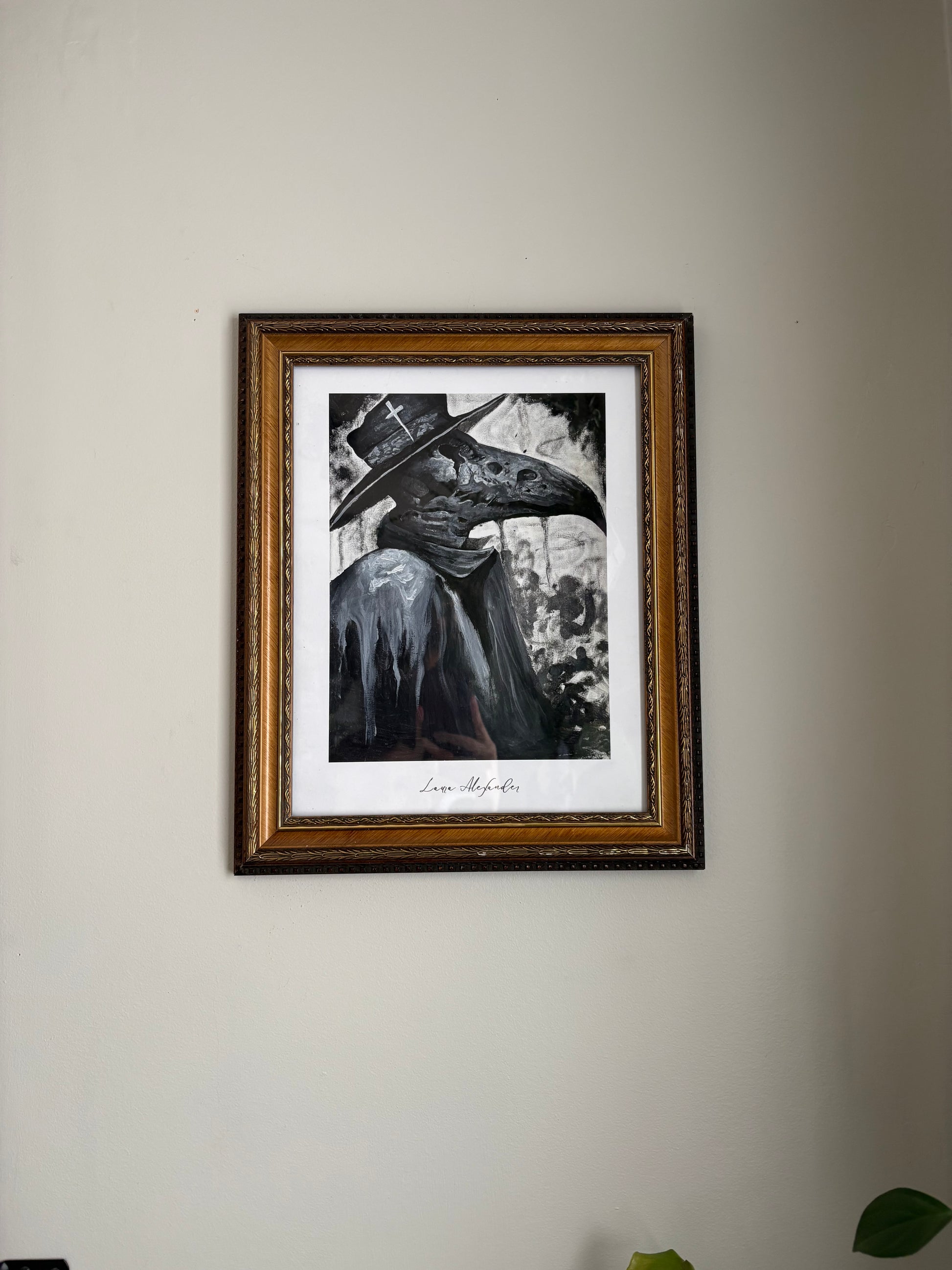 Framed black and white Laura Alexander - Fantasy Art Print - Plague Doctor artwork on a plain wall