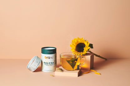 Tease focus and flow Tea packaging with a cup of tea and sunflower on a beige background