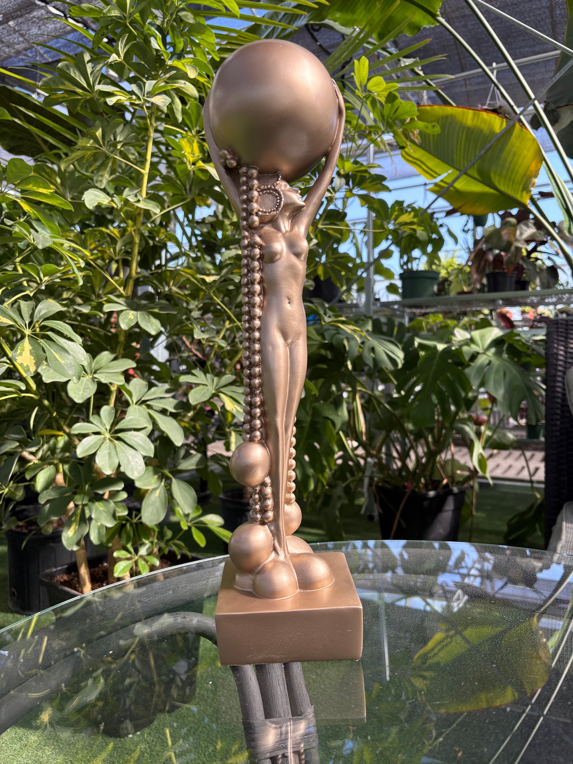 Frank Lloyd Wright Midway Garden Decor bronze statue placed in a greenhouse setting