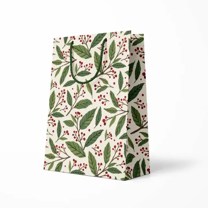 Gift bag with green leaf and red berry pattern on a white background