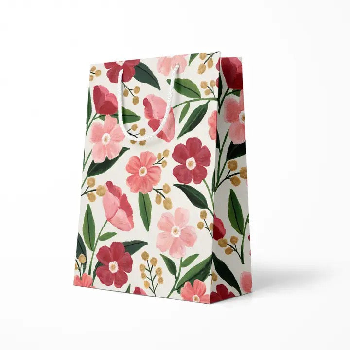 pink floral patterned gift bag on a white background