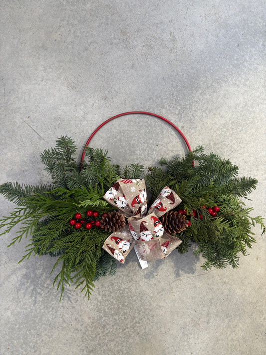 Hoop Golden Forest Wreath 24" wreath with greenery, pinecones, and red berries on a light gray background