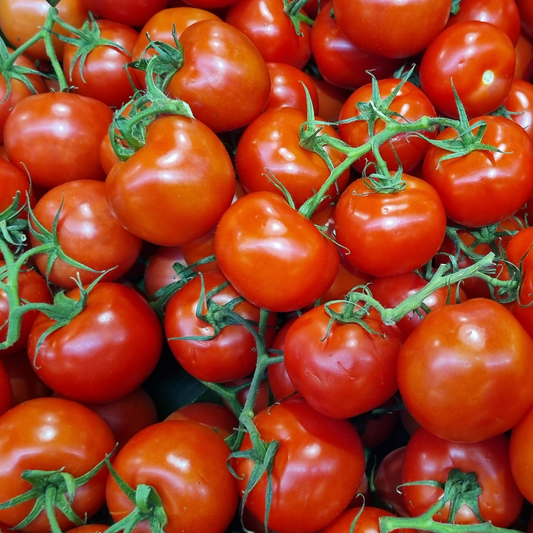 the screen is full of small bright red heartbreakers valley tomatoes with green stems