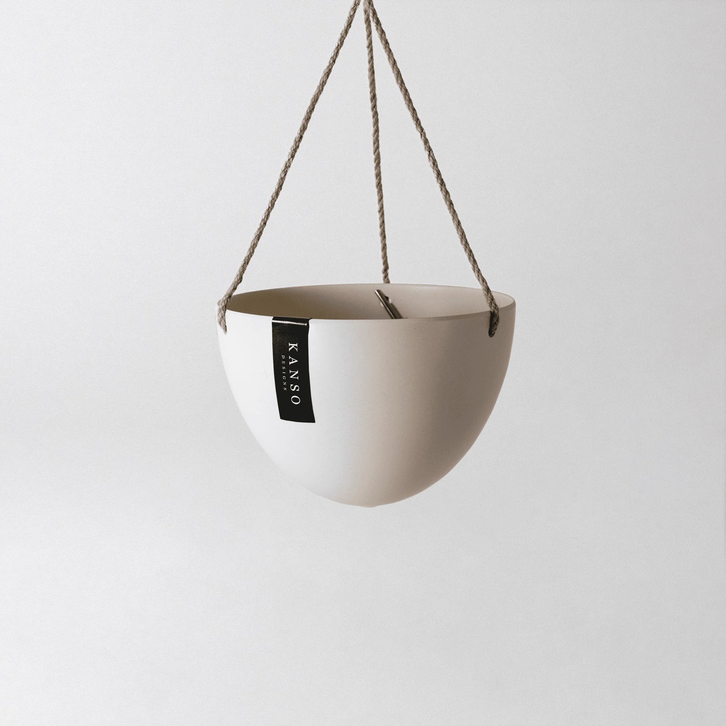 white hanging planter with 'KANSO' designs label on a white background