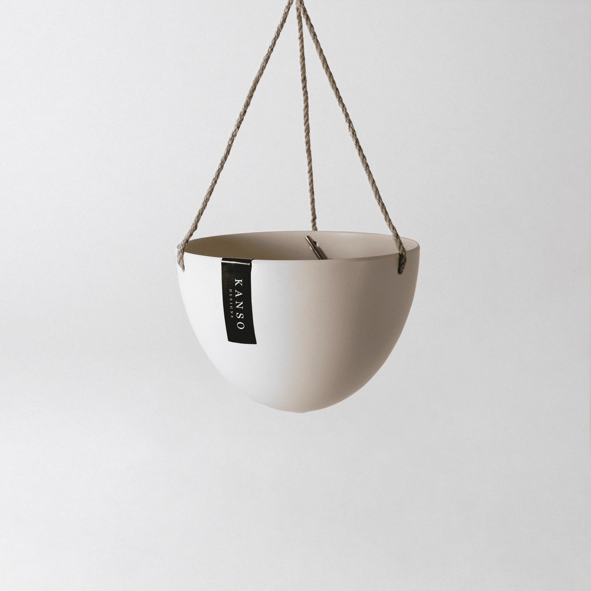 white hanging planter with 'KANSO' designs label on a white background