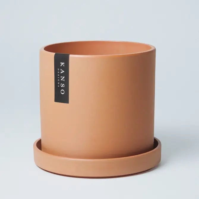 terracotta coloured pot with a white background