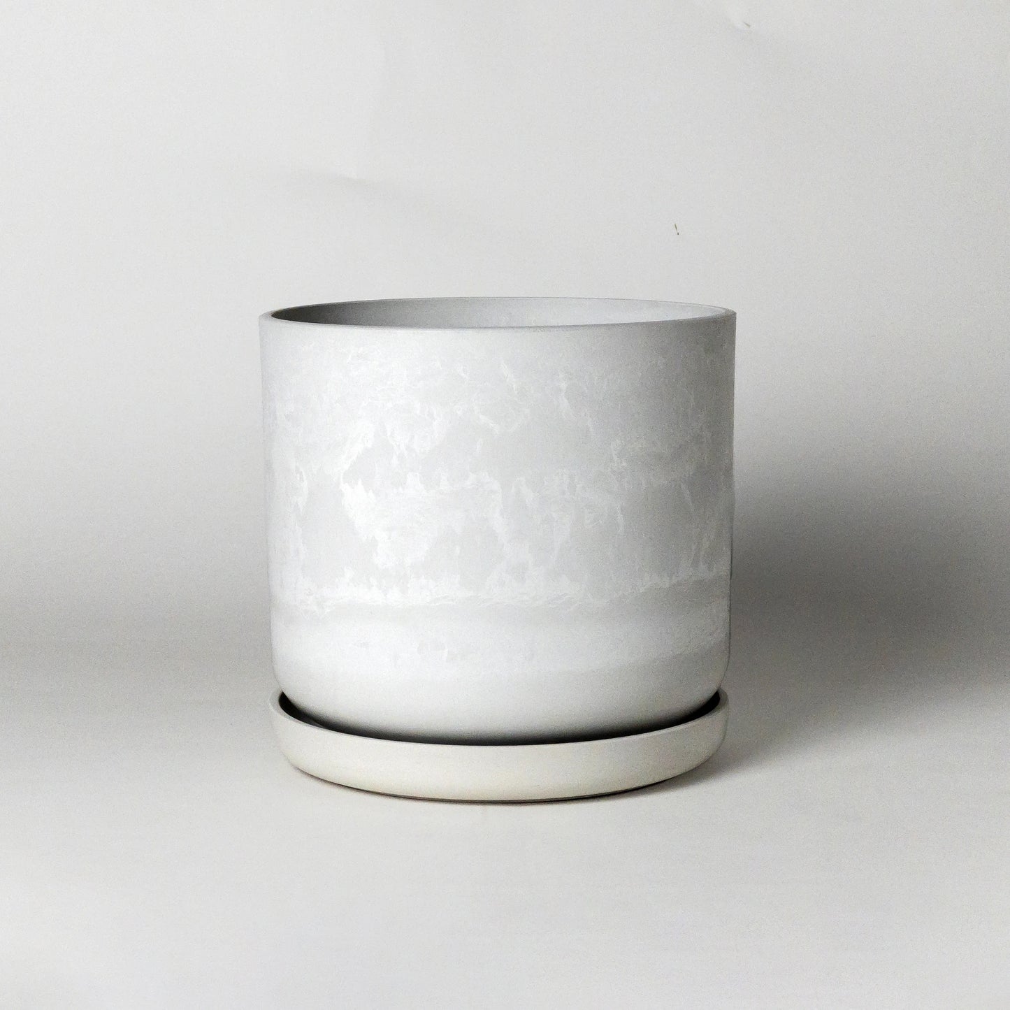 White stone plant pot on a light gray background