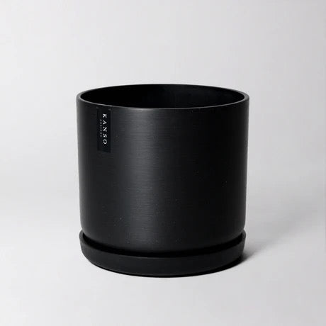 Black planter with 'KANSO Designs' branding on a light gray background