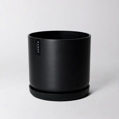 Black planter with 'KANSO Designs' branding on a light gray background