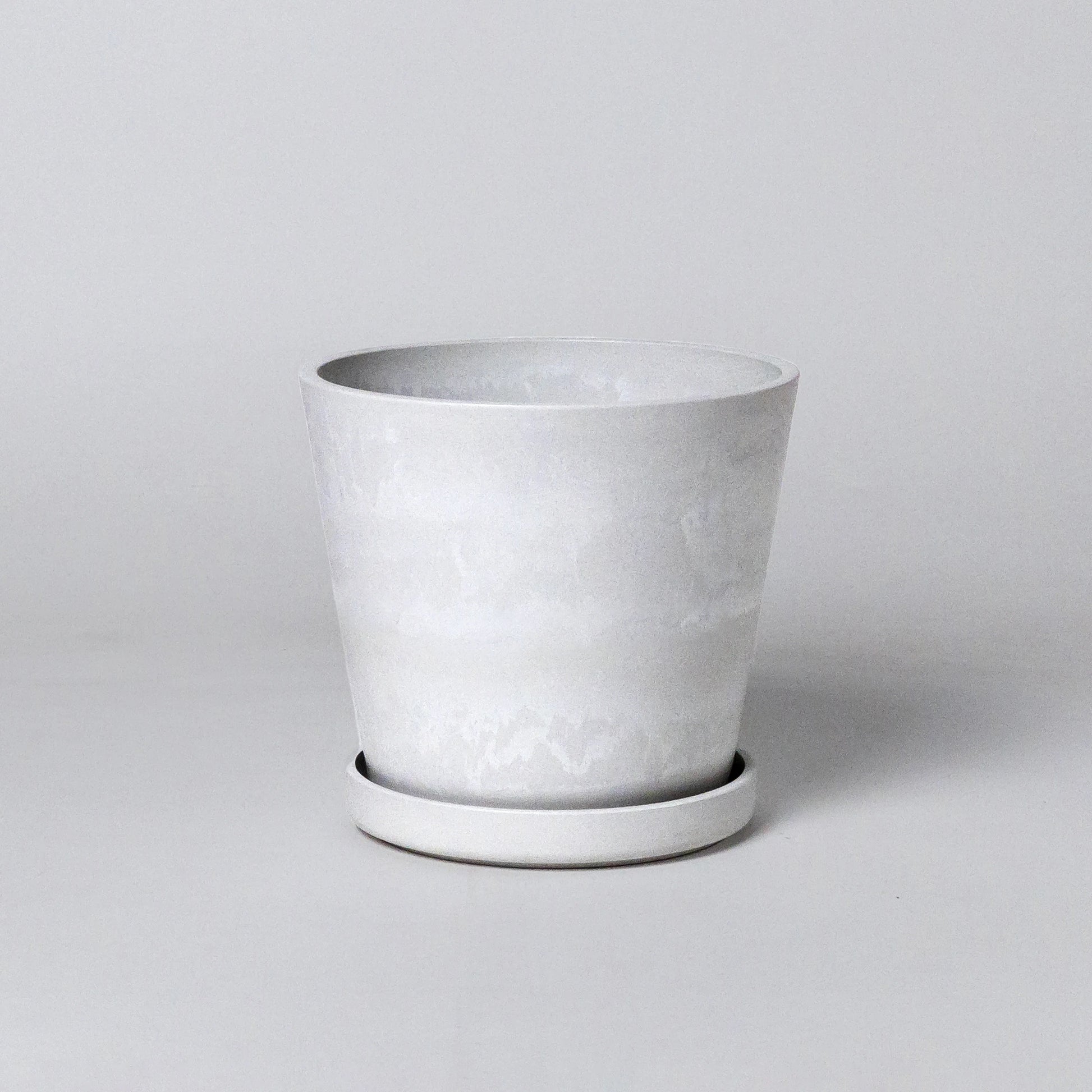 White stone planter on a light gray background