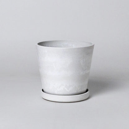 White stone planter on a light gray background