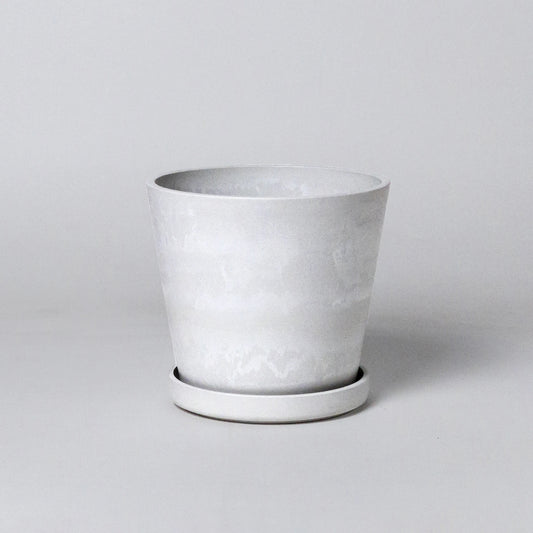 White stone planter on a light gray background