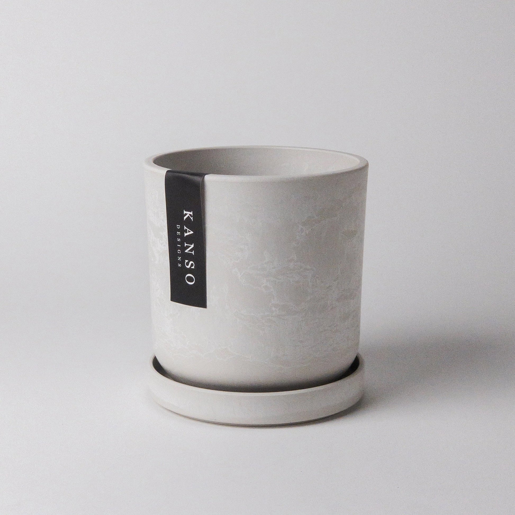 white stone planter with 'KANSO' label on a light gray background
