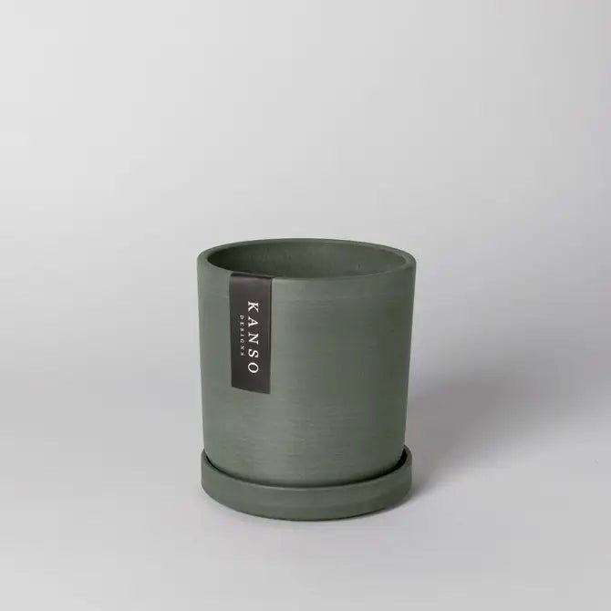 Olive Green plant pot with a Kanso Designs label on a light gray background