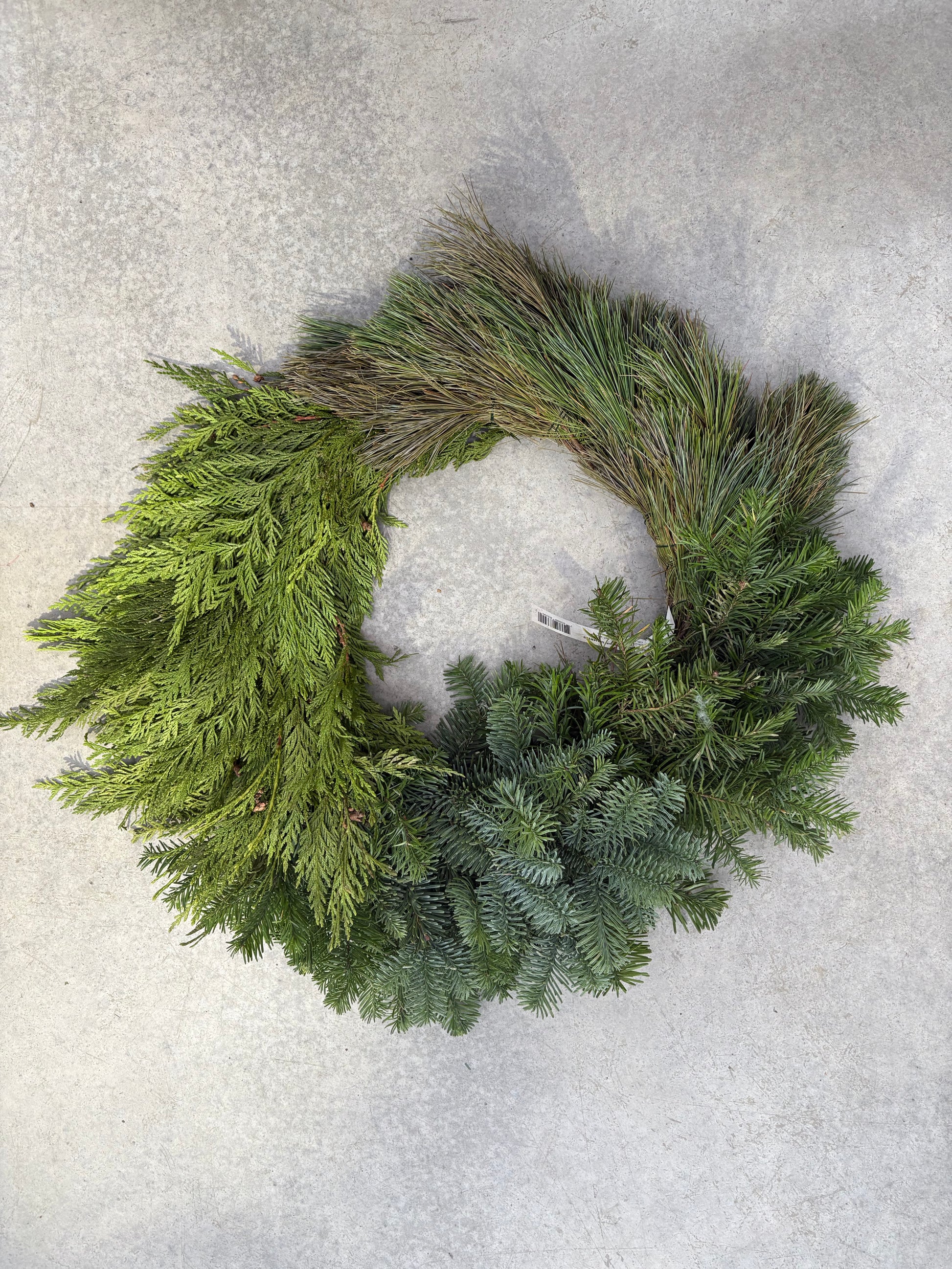 Green Modern Block Wreath 24"  on a light gray surface