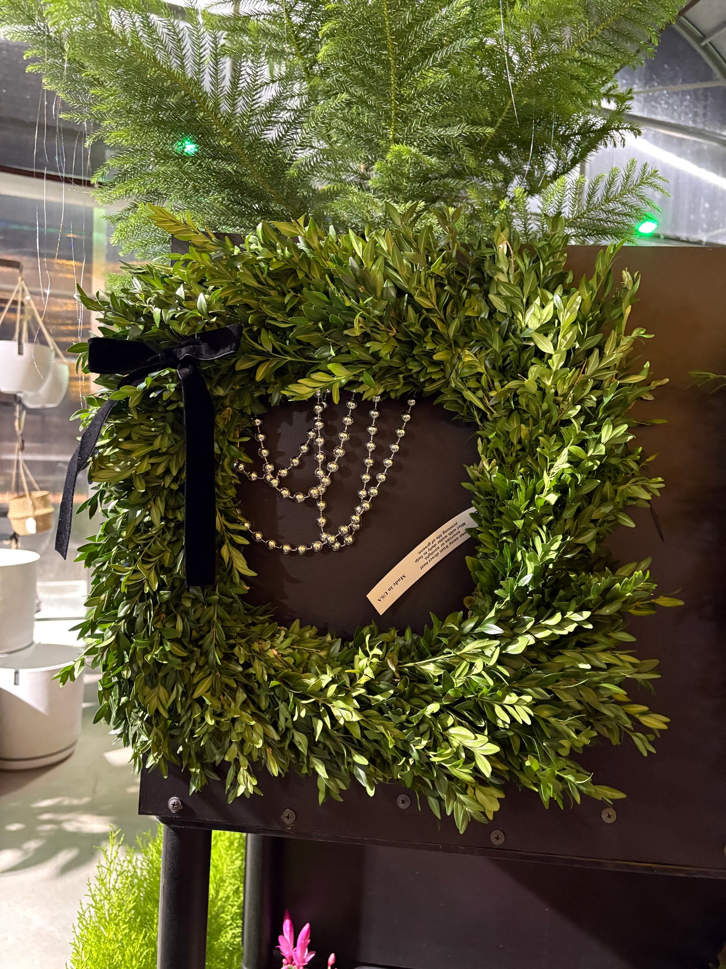 Green specialty live wreath with a blackboard and decorative items on a table