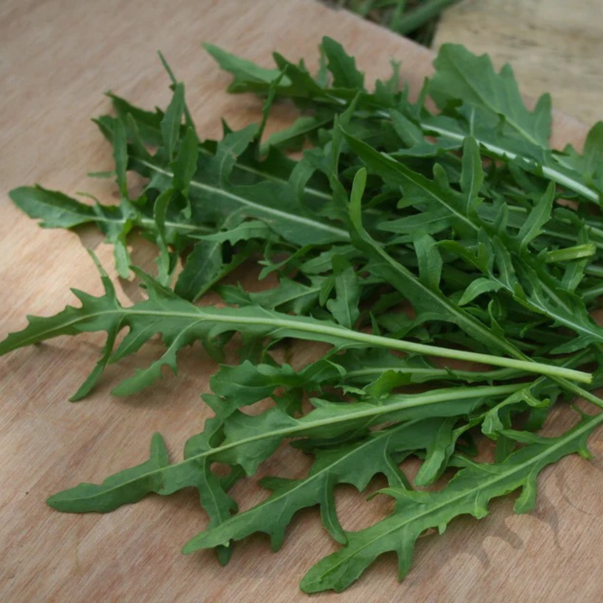 picture of Surrey arugula laying on a wooden block 