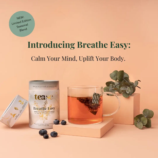 Tea packaging and cup with 'tease' brand on a peach background