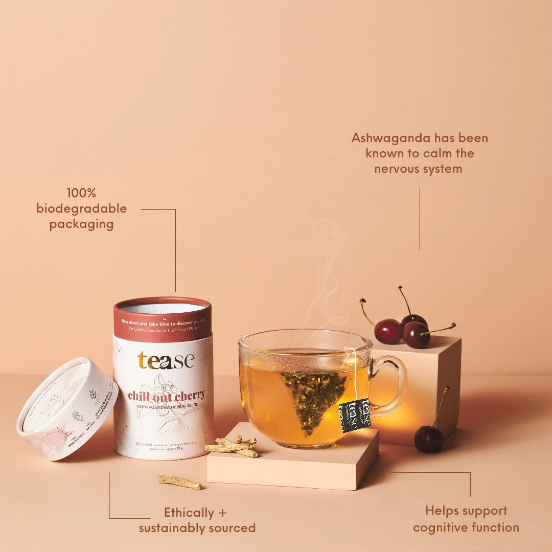 Tea packaging with a cup of tea and cherries on a beige background