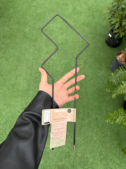 a person holding "Tetris" Metal Trellis against green background