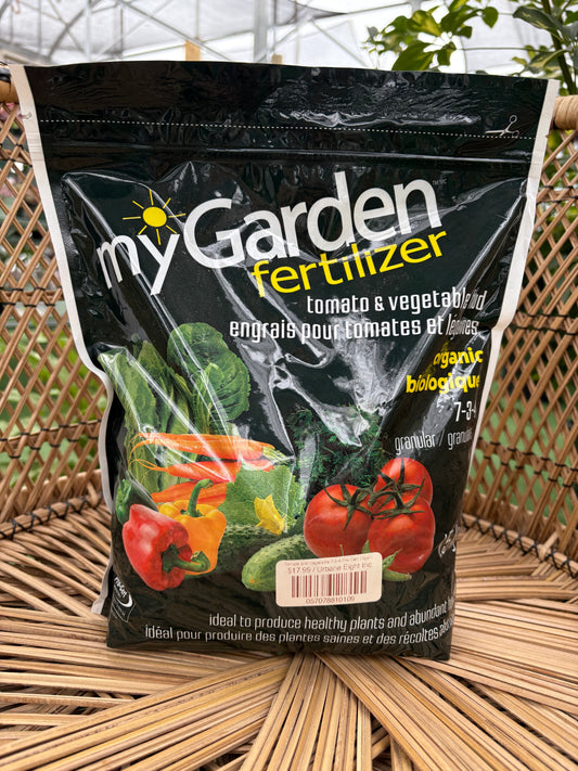 Bag of garden fertilizer with vegetables on a wicker chair