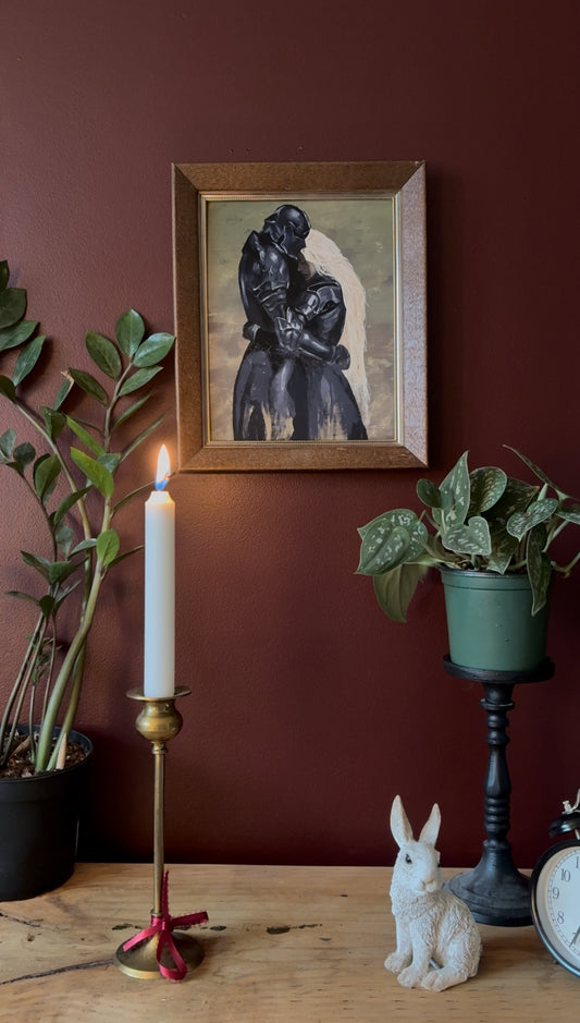 a fantasy inspired art print of a woman and a man both dressed in armour holding each other