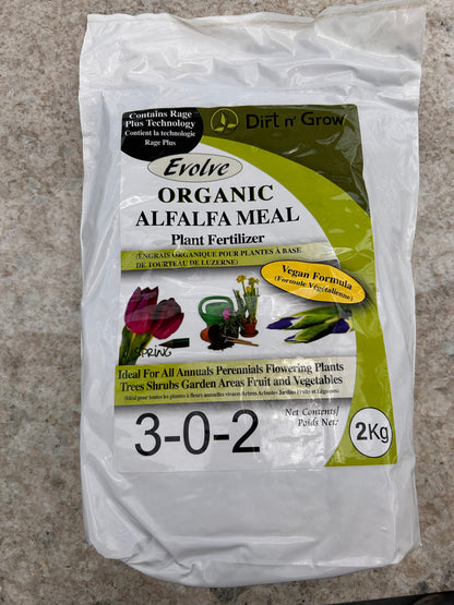 Package of Evolve Organic Alfalfa Meal plant fertilizer on a concrete surface